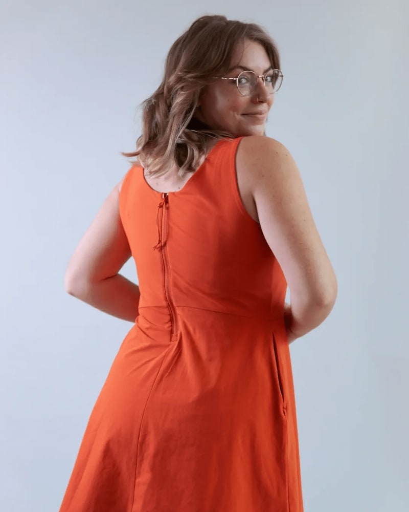 Back of a model wearing a size 4X get dirty dress in burnt ochre by alder apparel. | dia_product_style_image_id:300605